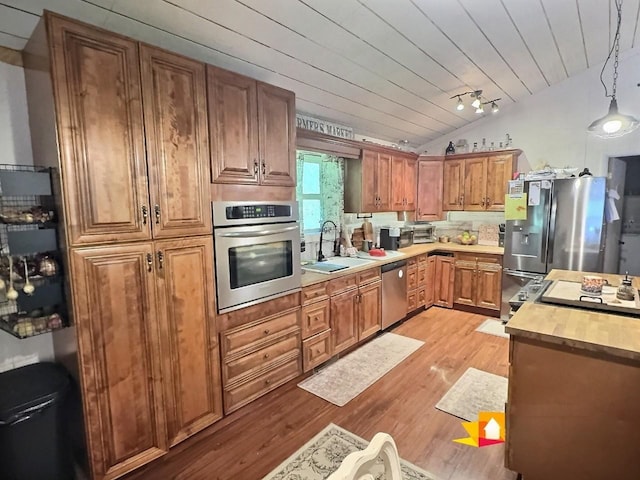1 Julie Ln, Pleasant Shade, TN 37145 - kitchen with appliances with stainless steel finishes, lofted ceiling, light wood-style flooring, wood ceiling, and brown cabinetry