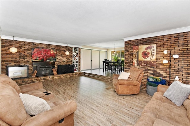19 Horseshoe Bend Rd, Leoma, TN 38468 - living room with brick wall, wood finished floors, a fireplace, and ornamental molding