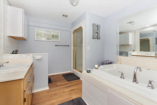 19 Horseshoe Bend Rd, Leoma, TN 38468 - bathroom featuring vanity, a garden tub, wood finished floors, and a shower stall