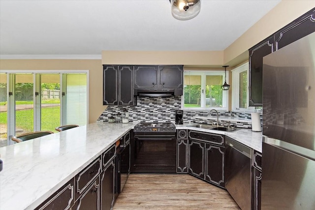 19 Horseshoe Bend Rd, Leoma, TN 38468 - kitchen with appliances with stainless steel finishes, backsplash, light wood finished floors, a peninsula, and ornamental molding