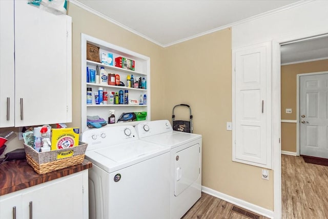 19 Horseshoe Bend Rd, Leoma, TN 38468 - washroom featuring light wood finished floors, cabinet space, ornamental molding, and separate washer and dryer