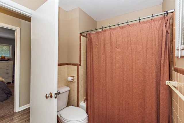 19 Horseshoe Bend Rd, Leoma, TN 38468 - bathroom featuring tile walls, wood finished floors, shower / tub combo, and wainscoting