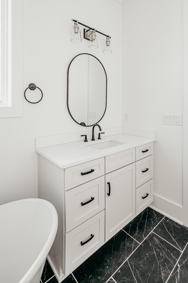 2013 Hector Dr, Thompsons Station, TN 37179 - bathroom with vanity, a freestanding tub, and marble finish floors