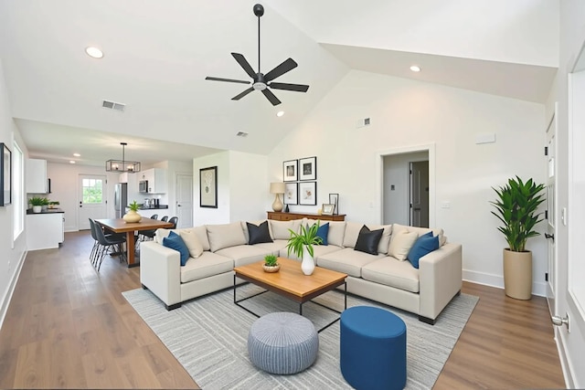 1142 Snow Ave, Madison, TN 37115 - living area featuring wood finished floors, recessed lighting, ceiling fan, high vaulted ceiling, and a chandelier
