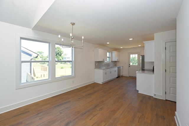 1142 Snow Ave, Madison, TN 37115 - kitchen featuring a chandelier, light countertops, dark wood-style floors, white cabinetry, and backsplash
