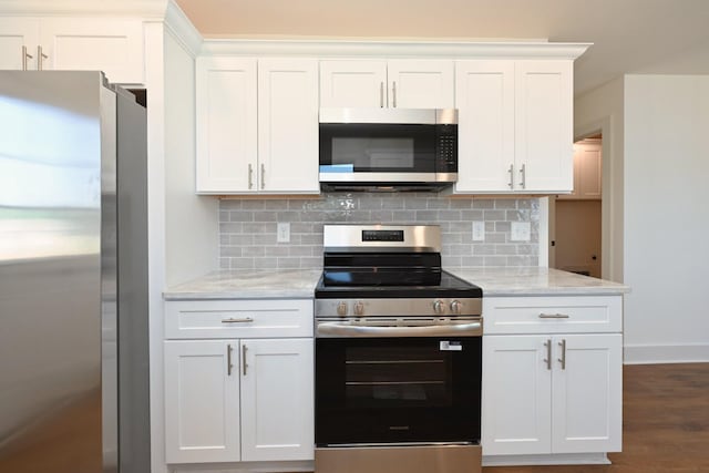 1142 Snow Ave, Madison, TN 37115 - kitchen featuring appliances with stainless steel finishes, backsplash, white cabinetry, and light stone counters