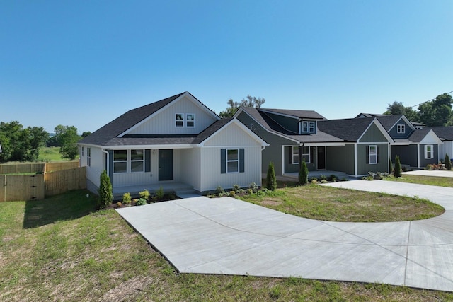1142 Snow Ave, Madison, TN 37115 - modern farmhouse featuring a porch, roof with shingles, and concrete driveway