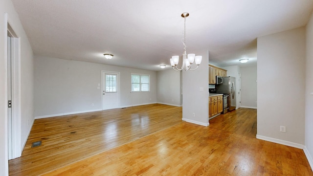 4321 Lynchburg Rd, Winchester, TN 37398 - unfurnished living room with a chandelier and light wood-style floors