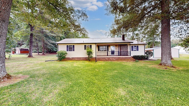 4321 Lynchburg Rd, Winchester, TN 37398 - ranch-style house featuring a chimney, a front lawn, a porch, and a metal roof