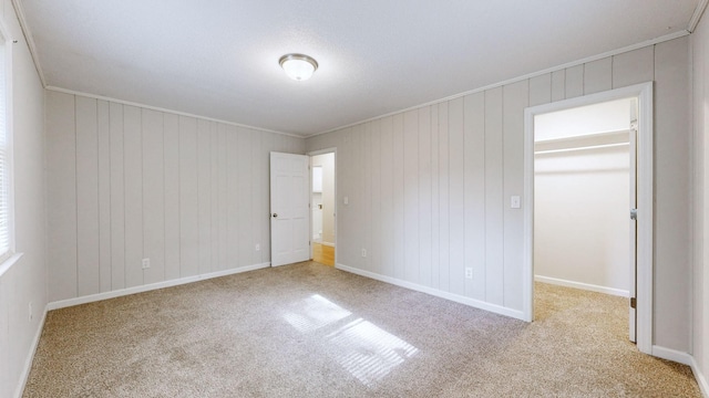 4321 Lynchburg Rd, Winchester, TN 37398 - unfurnished bedroom featuring carpet floors, a walk in closet, ornamental molding, and a closet