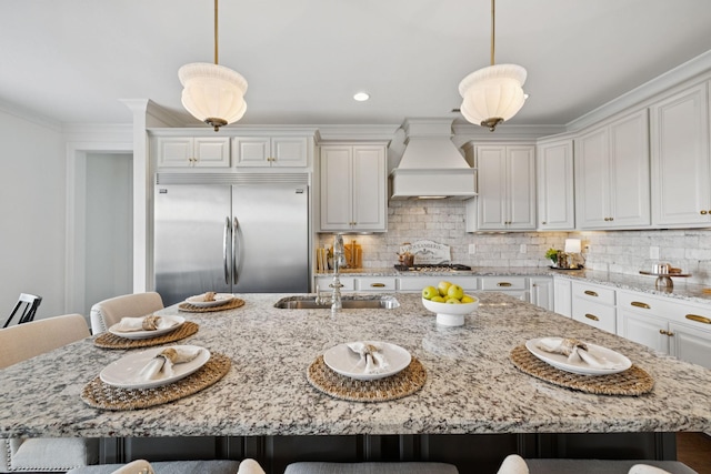 923 Hornsby Dr, Franklin, TN 37064 - kitchen featuring appliances with stainless steel finishes, custom exhaust hood, a kitchen breakfast bar, tasteful backsplash, and crown molding