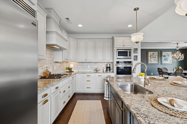 923 Hornsby Dr, Franklin, TN 37064 - kitchen with built in appliances, light stone counters, pendant lighting, dark wood-style flooring, and backsplash