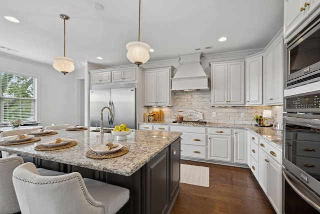 923 Hornsby Dr, Franklin, TN 37064 - kitchen with built in appliances, premium range hood, white cabinets, dark wood finished floors, and tasteful backsplash