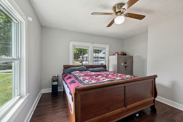 410 England St E, Cowan, TN 37318 - bedroom with multiple windows, dark wood finished floors, a ceiling fan, and a textured ceiling