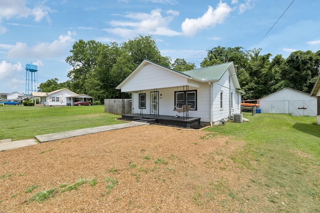 410 England St E, Cowan, TN 37318 - view of front of home featuring a porch, a front lawn, a metal roof, and a garage