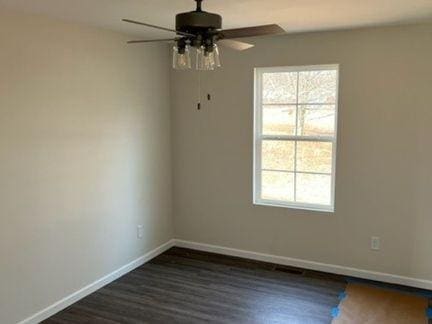 484 Meadowbrook Dr, Mcminnville, TN 37110 - spare room with ceiling fan, healthy amount of natural light, and dark wood-style flooring