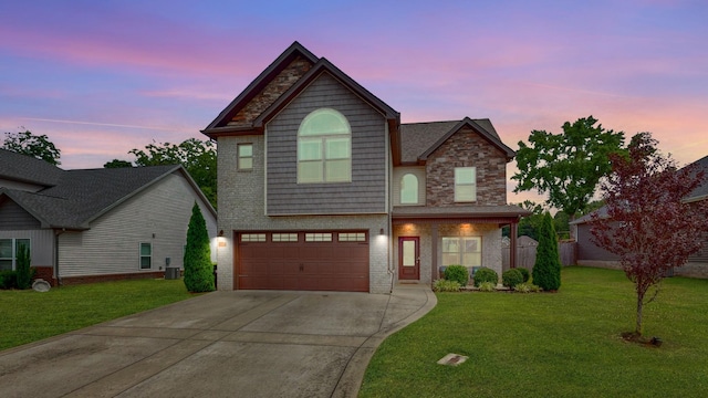1197 Ewing Way, Clarksville, TN 37043 - view of front of house featuring driveway, a lawn, an attached garage, brick siding, and stone siding