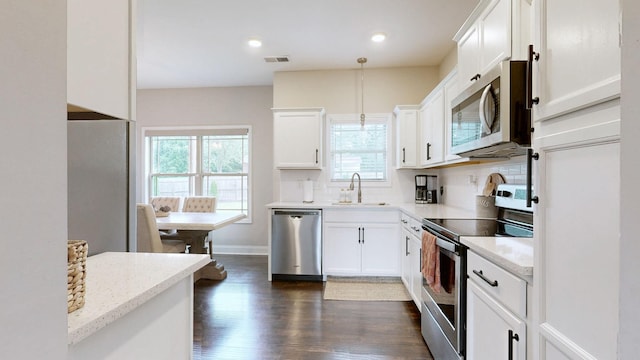 1197 Ewing Way, Clarksville, TN 37043 - kitchen with stainless steel appliances, plenty of natural light, dark wood-style flooring, white cabinetry, and recessed lighting