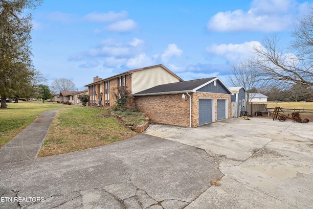 602 Mize Cir, Seymour, TN 37865 - view of side of property with brick siding, an attached garage, driveway, and a chimney