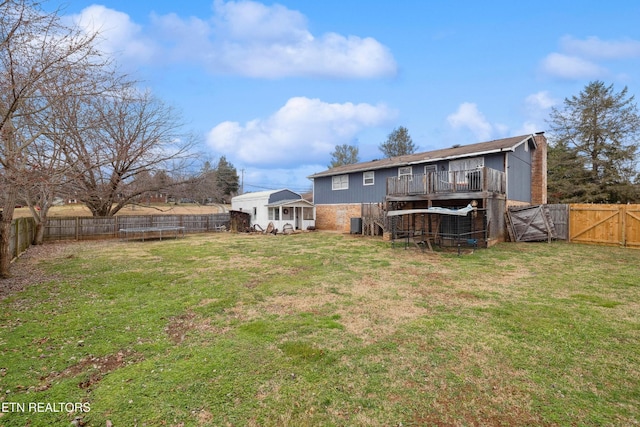 602 Mize Cir, Seymour, TN 37865 - rear view of house with a fenced backyard, a trampoline, and a gate