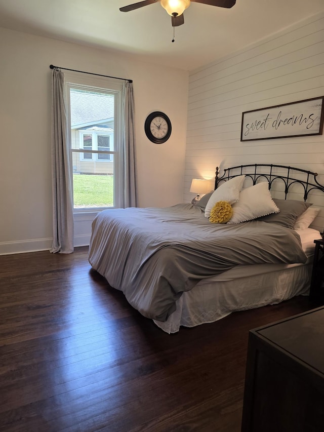 105 3rd Ave, Columbia, TN 38401 - bedroom with wood finished floors, a ceiling fan, and wood walls
