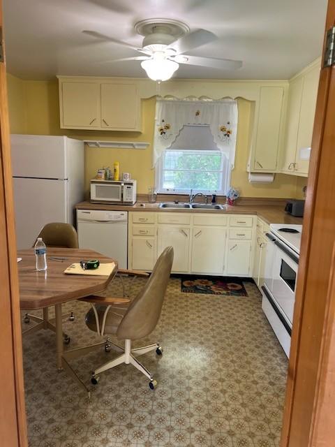 4805 Bowfield Dr, Antioch, TN 37013 - kitchen with white appliances, ceiling fan, cream cabinets, and an office area
