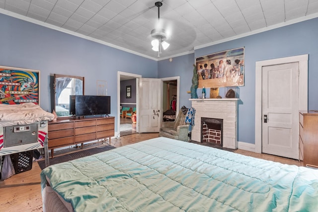 104 3rd Ave, Columbia, TN 38401 - bedroom featuring ornamental molding, wood finished floors, a brick fireplace, and ceiling fan