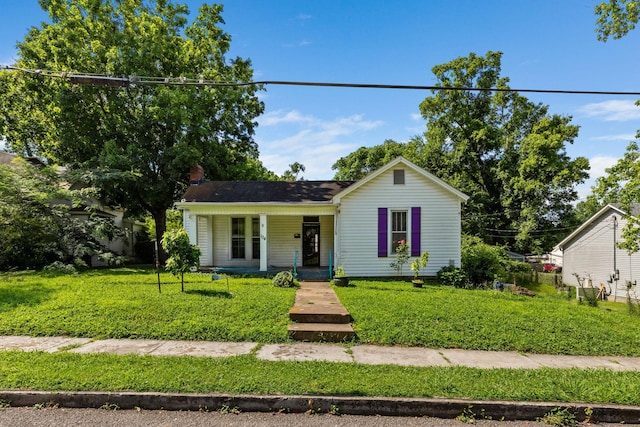 104 3rd Ave, Columbia, TN 38401 - view of front of house featuring a porch, a front lawn, and a chimney