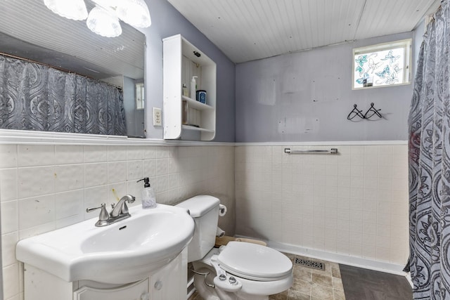 104 3rd Ave, Columbia, TN 38401 - bathroom with tile walls, wainscoting, a shower with shower curtain, and vanity