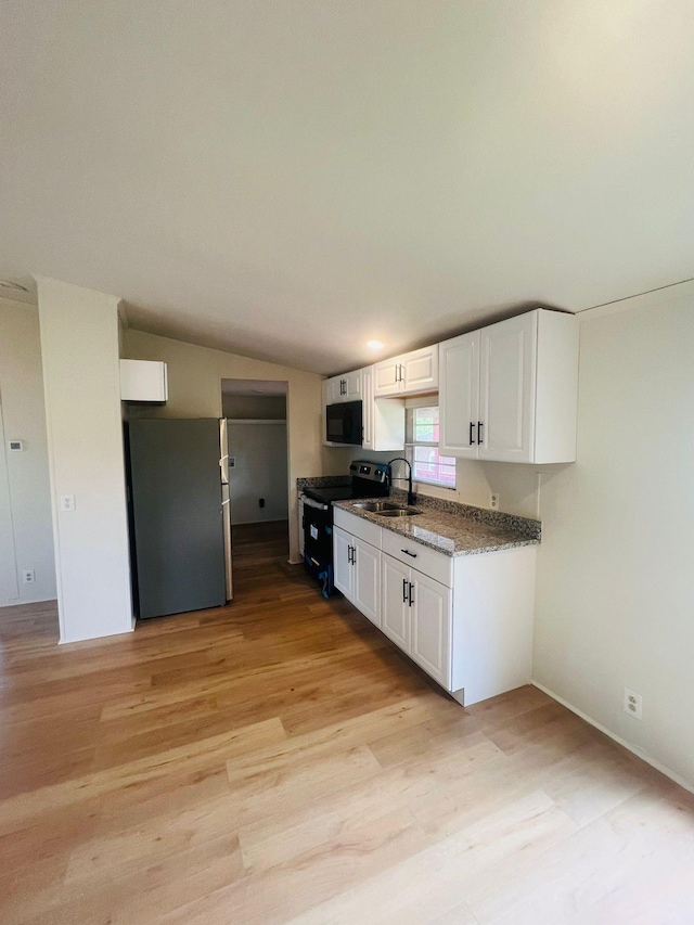 11120 Central Pike, Mount Juliet, TN 37122 - kitchen featuring electric range oven, black microwave, freestanding refrigerator, white cabinetry, and lofted ceiling