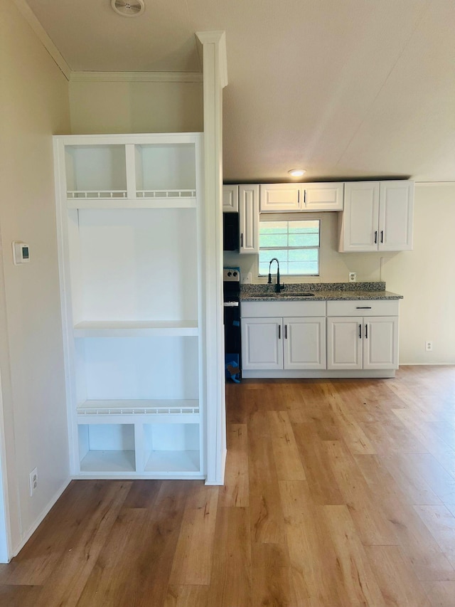11120 Central Pike, Mount Juliet, TN 37122 - kitchen with light wood finished floors, white cabinets, crown molding, stainless steel electric range oven, and black microwave
