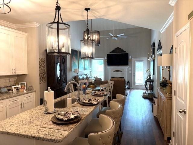 967 Horse Mountain Rd Unit 1E, Shelbyville, TN 37160 - kitchen featuring black fridge, open floor plan, ceiling fan, a kitchen bar, and white cabinetry