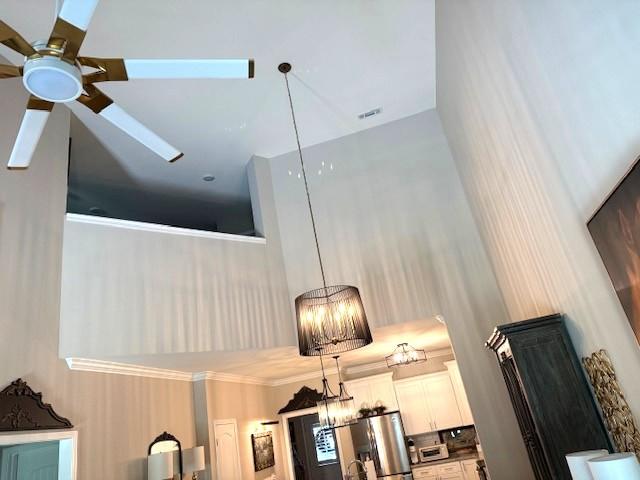 967 Horse Mountain Rd Unit 1E, Shelbyville, TN 37160 - detailed view of a ceiling fan, stainless steel fridge, white cabinetry, and hanging light fixtures