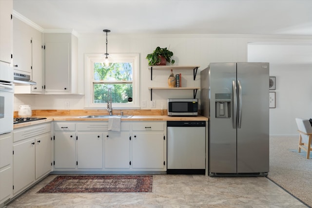 1211 Taylor Pl, Murfreesboro, TN 37129 - kitchen featuring stainless steel appliances, light countertops, crown molding, white cabinetry, and pendant lighting