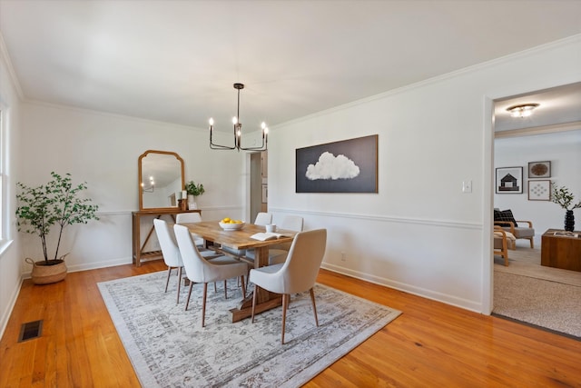 1211 Taylor Pl, Murfreesboro, TN 37129 - dining room with a chandelier, crown molding, and light wood finished floors
