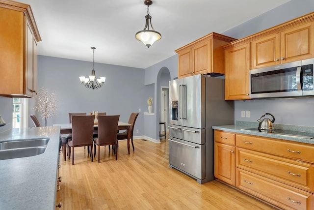 343 Belinda Pkwy, Mount Juliet, TN 37122 - kitchen featuring stainless steel appliances, arched walkways, decorative light fixtures, light wood-style floors, and a chandelier