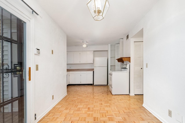 3880 Priest Lake Dr Unit 21, Nashville, TN 37217 - kitchen with range, freestanding refrigerator, white cabinetry, ceiling fan, and light countertops