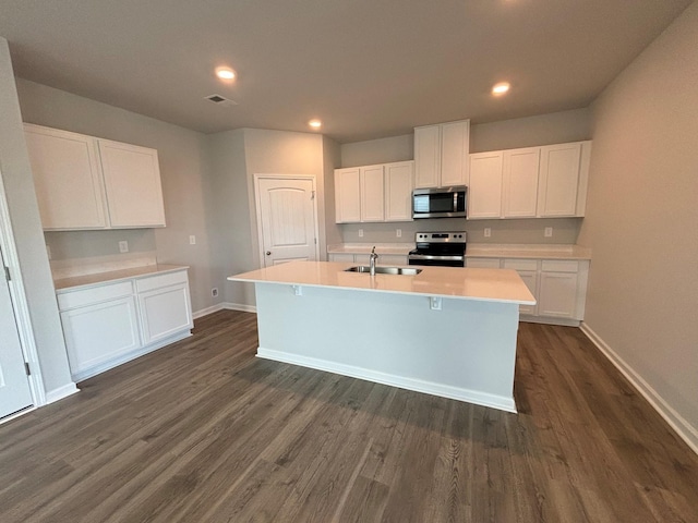 4902 Mowbray Way, Murfreesboro, TN 37129 - kitchen featuring appliances with stainless steel finishes, an island with sink, dark wood-style flooring, white cabinetry, and light countertops