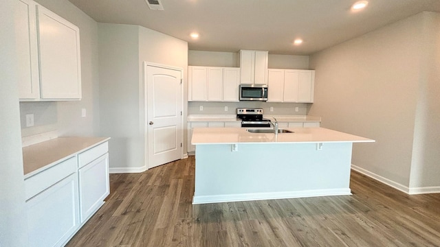 4902 Mowbray Way, Murfreesboro, TN 37129 - kitchen featuring appliances with stainless steel finishes, a kitchen island with sink, dark wood-type flooring, recessed lighting, and light countertops