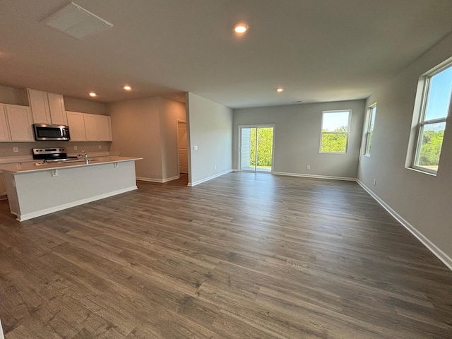 4902 Mowbray Way, Murfreesboro, TN 37129 - kitchen featuring appliances with stainless steel finishes, open floor plan, recessed lighting, white cabinets, and a kitchen island with sink