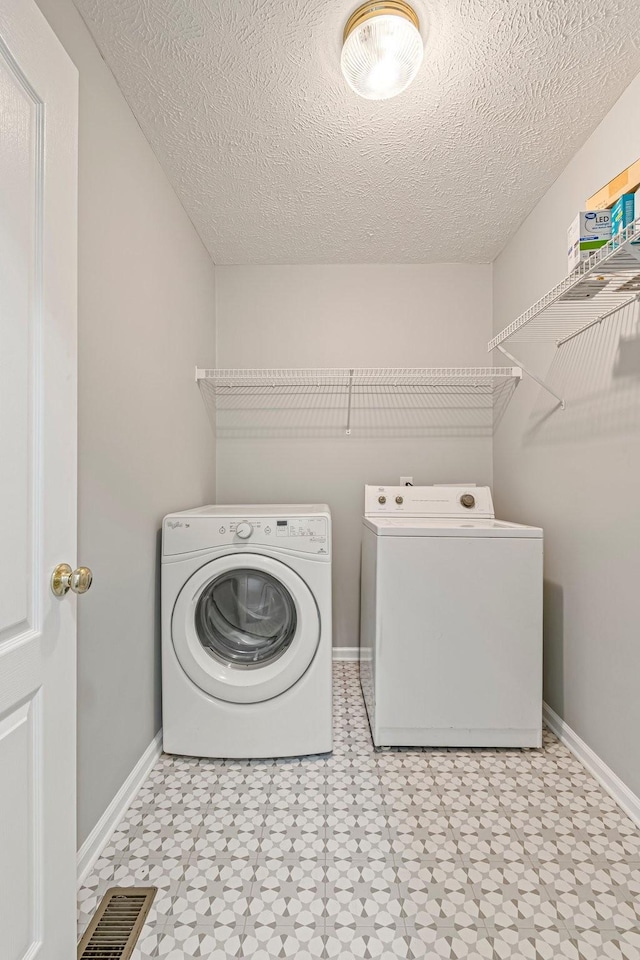 2415 Franklin Ln, Murfreesboro, TN 37130 - laundry room with separate washer and dryer, tile patterned floors, and a textured ceiling