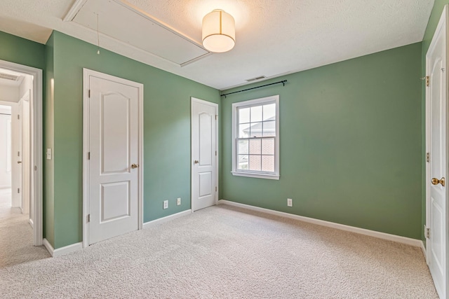 2415 Franklin Ln, Murfreesboro, TN 37130 - unfurnished bedroom with attic access, carpet flooring, and a textured ceiling