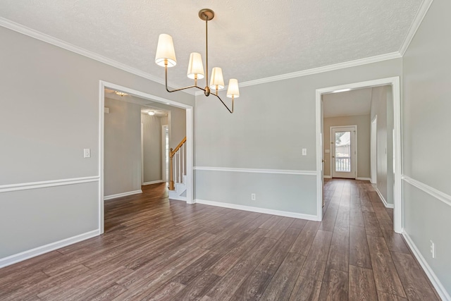 2415 Franklin Ln, Murfreesboro, TN 37130 - spare room with a textured ceiling, dark wood finished floors, a chandelier, stairway, and ornamental molding
