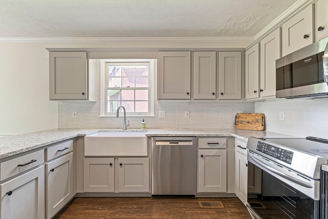 2415 Franklin Ln, Murfreesboro, TN 37130 - kitchen with appliances with stainless steel finishes, ornamental molding, a textured ceiling, gray cabinets, and dark wood-style floors