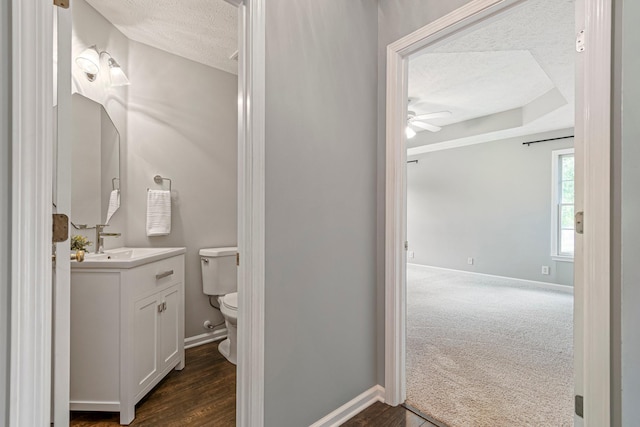 2415 Franklin Ln, Murfreesboro, TN 37130 - half bathroom featuring a textured ceiling, a ceiling fan, vanity, and wood finished floors