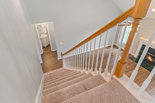 2415 Franklin Ln, Murfreesboro, TN 37130 - staircase with wood finished floors, a tile fireplace, a towering ceiling, and a ceiling fan