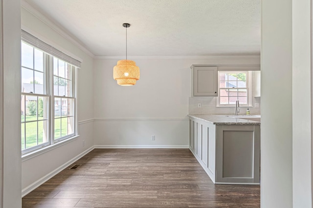 2415 Franklin Ln, Murfreesboro, TN 37130 - unfurnished dining area featuring dark wood-style floors, ornamental molding, and a textured ceiling