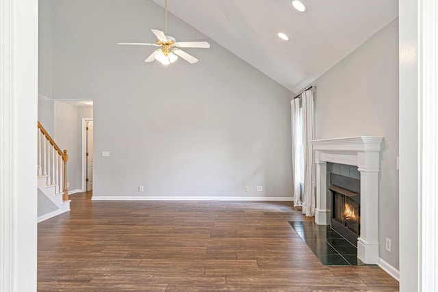 2415 Franklin Ln, Murfreesboro, TN 37130 - unfurnished living room featuring a ceiling fan, a tile fireplace, wood finished floors, high vaulted ceiling, and stairway