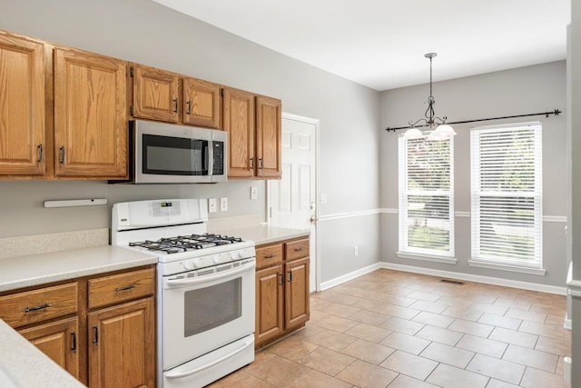 4416 Churchill Pl, Old Hickory, TN 37138 - kitchen featuring stainless steel microwave, white range with gas stovetop, and light countertops