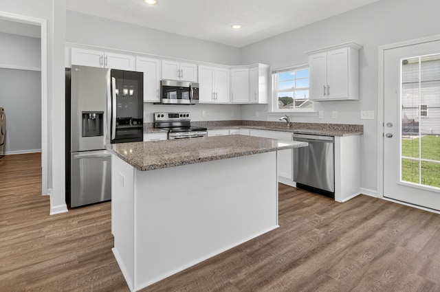 77 Frost St, Decherd, TN 37324 - kitchen featuring appliances with stainless steel finishes, white cabinetry, a center island, plenty of natural light, and recessed lighting